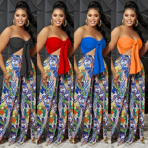 Detail of multi-color wide leg pants with side slits and bandeau bow top set