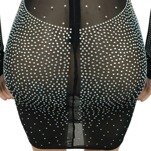 Detail of black sheer mesh fabric with shiny rhinestones on a slim fit dress