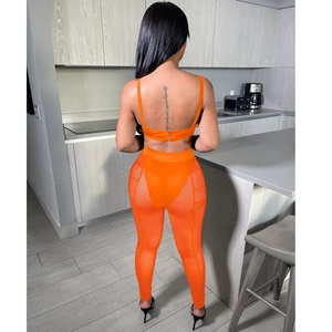 Vista detallada del conjunto de dos piezas naranja con diseño de malla en la espalda