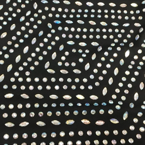 Detailed macro view of sparkling round and marquise rhinestones on black evening dress fabric