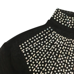 Detail of high neck black mesh dress with radiant AB rhinestones and sheer fabric