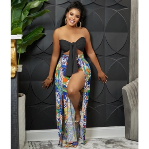Detail of black strapless bow top and high slit printed skirt set for women