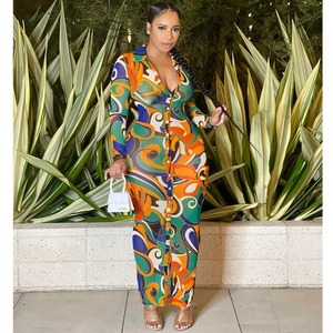 Detail of colorful abstract print and button-down closure on a long sleeve maxi dress