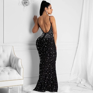 Detail of elegant black backless evening dress with white pearls and slim straps