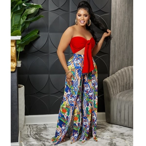 Detail of red bandeau top with bow and paisley print high-waist wide-leg trousers
