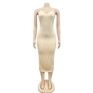 Close-up of beige bodycon dress featuring shimmering silver rhinestones and thin straps