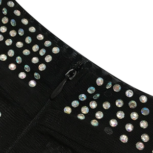 Detail of sheer black mesh dress with colorful rhinestones and hidden back zipper