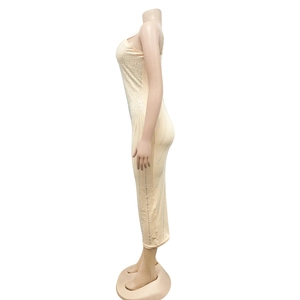 Detail of slim fit beige maxi dress with sparkling silver rhinestones and bodycon cut