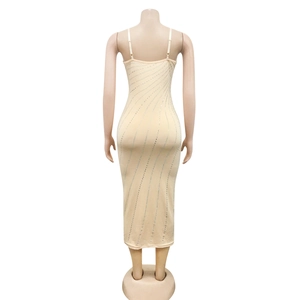 Detail view of the back of a beige midi dress with silver rhinestones and thin straps