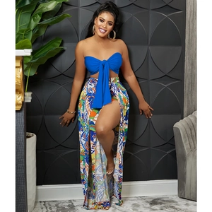 Detail of royal blue tube top with large bow and high-slit floral printed maxi skirt