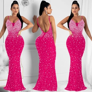 Detailed view of fuchsia mermaid evening gown with white pearls and backless design