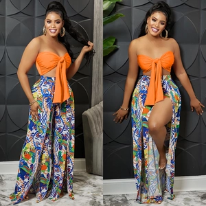 Women's 2-piece set featuring orange bandeau top and printed high-slit wide leg trousers