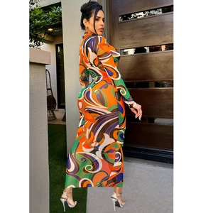 Detail of slim fit maxi dress featuring vibrant abstract geometric prints and long sleeves