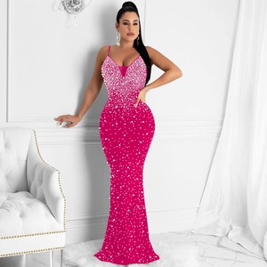 Close-up of pink slim-fit long dress featuring sparkling rhinestones and deep V-neck