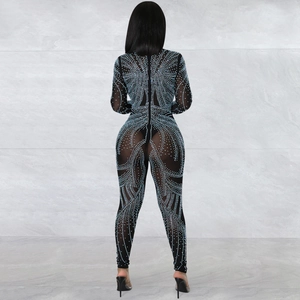 Detailed view of blue rhinestones on black mesh bodysuit with geometric swirl patterns