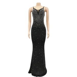 Detail of V-neck evening gown with rhinestones and mesh patchwork on black fabric