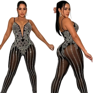 Detailed close-up of sparkling silver rhinestones and mesh on a black party jumpsuit