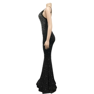 Close-up of black bodycon mermaid dress featuring high-density white pearl and rhinestone details