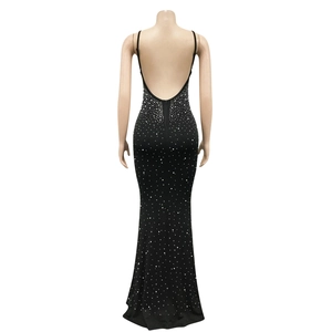 Close-up of the elegant backless design and rhinestone detailing on the black dress