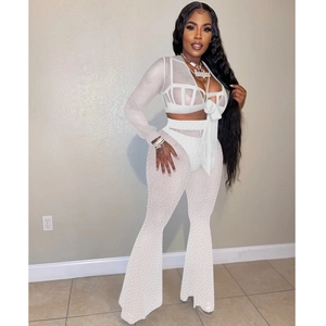 Detail of white mesh sheer two-piece set with pearl embellishments and tie-front top
