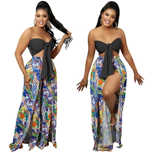 Detail of trendy backless tube top paired with high-slit vibrant floral print wide-leg pants