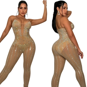 Close-up of sparkling rhinestones on sheer mesh jumpsuit with elegant nude fabric details