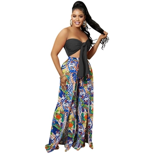 Detail of high-waist floral print wide-leg pants with side slit and bandeau top