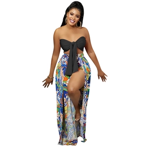 Detail view of bohemian high slit floral skirt and strapless black tie-front crop top set