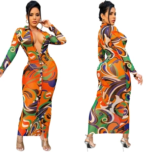 Detail of V-neck long sleeve dress with abstract geometric print and metal chain belt