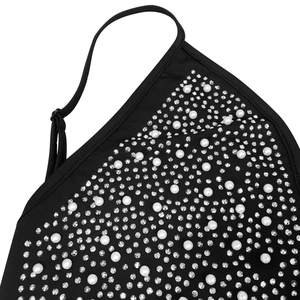 Close-up of black dress fabric featuring elegant faux pearls and shimmering rhinestones