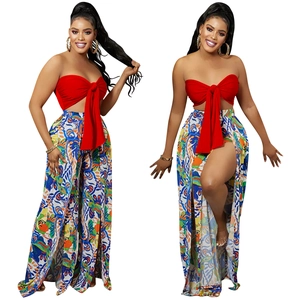 Detail of red bow tube top and vibrant geometric print high-slit wide leg pants set