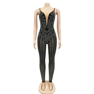 Close-up of black sleeveless bodysuit with rhinestones in floral and striped patterns