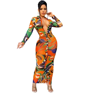 Detail of V-neck printed dress showing gold chain belt and geometric floral patterns