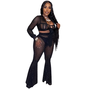 Close-up of black mesh fabric with sparkling rhinestones and lace-up sleeve detail