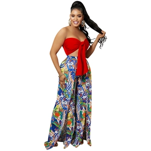 Detail of red tube top with bow and boho print high slit wide leg trousers