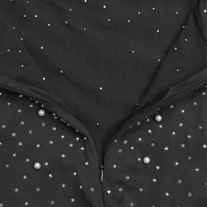 Close-up of black rhinestone dress showing the zipper and white pearl beadwork detail
