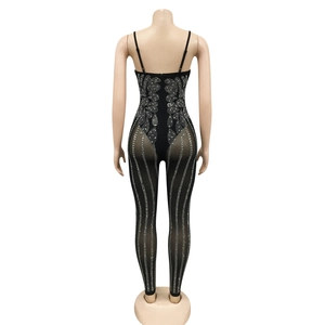 Detail of black mesh jumpsuit with silver rhinestone patterns and back zipper