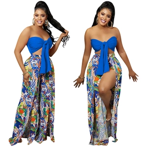 Detail of blue tube top with central bow and matching high-slit floral printed wide-leg pants