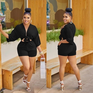 Women's black summer set featuring a deep V-neck tie-up top and high waisted slim fit shorts