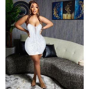Detail of white bodycon mini dress with deep V-neck and shimmering wave pattern rhinestones