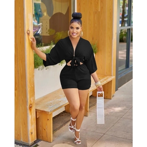 Detail view of black V-neck tie-front crop top and high-waisted shorts set for women