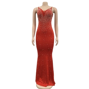 Detail of red rhinestone fish tail dress with sequins and elegant deep V-neckline
