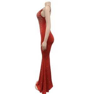 Detail view of red fishtall dress with halter neck and white pearl embellishments