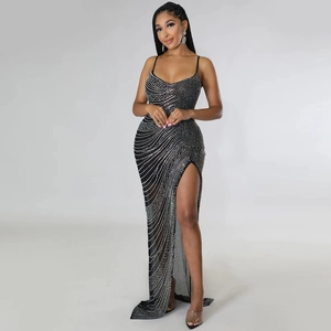 Detail of silver rhinestone wave patterns and high slit on a black mesh evening dress