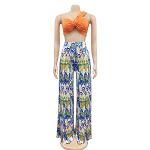 Detail of high waist wide leg pants with abstract tropical print and vibrant colors