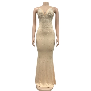 Detail of champagne evening dress with white pearls and rhinestones on deep V-neckline