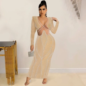 Detail of sheer mesh dress featuring intricate rhinestone patterns and side waist cut-outs