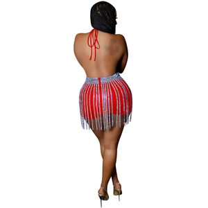 Detail of red backless halter top and sparkling silver rhinestone fringe on a mini skirt