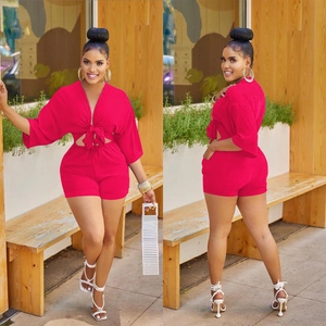 Detail of fuchsia summer two-piece set with V-neck tie-front top and high waist shorts