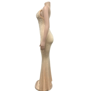 Detail of nude mermaid dress featuring elegant faux pearl embellishments and V-neckline